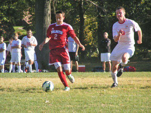 MELROSE MIDFIELDER Rowan Dempster chases down a Burlington attacker in Melrose's hard-fought 3-2 loss to the Red Devils. (Jennifer Gentile photo) 