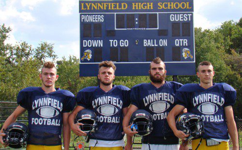 SPORTING NEW MOHAWKS, the Pioneer captains (from left) Cam Rondeau, Danny Sullivan, David Adams and Jon Knee pose in front of the new scoreboard at LHS Stadium. The first football home game of the season will be played in the new stadium on Friday, Oct. 10.                                                                                                             (Tom Condardo Photo)