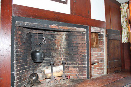FIREPLACES were necessary to provide both warmth and a means of cooking in the homes of the early inhabitants of town and as such are quite prominent in all of the homes on the historic house tour.  This fireplace in the present-day dining room of the Joseph Tapley House includes a beehive oven at the far right, one of two such ovens in the home.                                 (Maureen Doherty Photo)