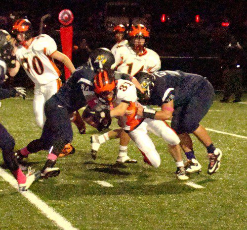 CRUNCH TIME. Pioneers Nick Contardo (34) and Spencer Balian (76) converge on Ipswich running back Charlie Gillis. The Tigers’ standout back was held to 39 yards rushing in the game.          (Tom Condardo Photo)
