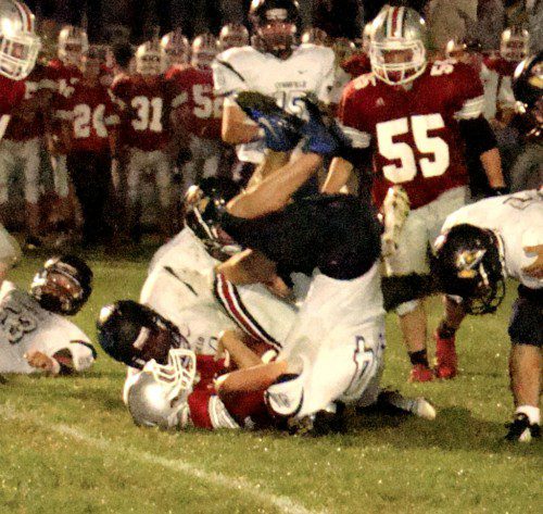 UPSY DAISY. Drew Balestrieri (44) takes a different angle to bring down this Amesbury runner Friday night.    (Tom Condardo Photo)