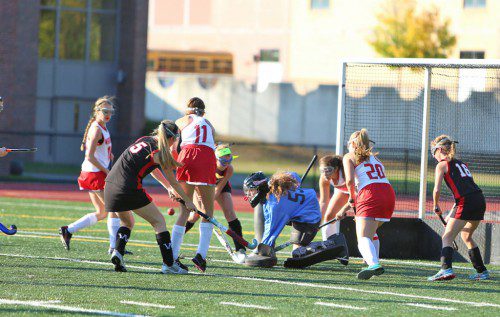 SENIOR GOALIE Miriam Wood (#55) turned away 25 shots by Winchester yesterday afternoon at Beasley Field. Shannon Livingston (#11) and Hayley Kaddaras (#20) help out on the play. The Warriors gave up three first half goals and dropped a 3-0 contest. (Donna Larsson Photo)