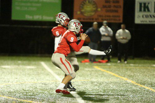 THE WARRIORS ran a fake on the PAT conversion attempt after their third touchdown last Friday night against Burlington at Landrigan Field. Senior Chris Sapanaro (#6) fakes the kick, while senior QB Will Bergendahl (#9) gets ready to throw the ball. (Donna Larsson Photo)