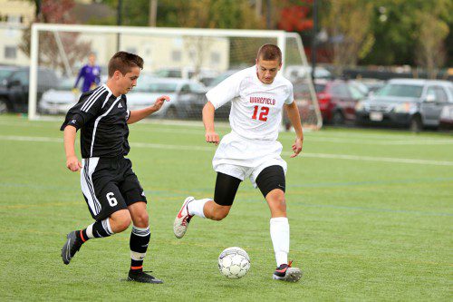 JOE HURTON, a senior, moves the ball up field during a recent contest. The Warrior boys’ soccer team played Burlington to a 1-1 tie on Saturday afternoon at Walton Field to clinch its first state tournament berth since 1999. (Donna Larsson File Photo)