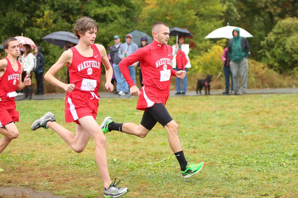 SENIOR JACKSON Gallagher (right) and junior Alec Rodgers (left) both ran well as did the rest of the Warrior boys’ cross country team yesterday afternoon against Melrose. Gallagher posted a fourth place time of 17:05 and Rodgers posted a ninth place time of 17:41. Wakefield came up short against the Red Raiders, 19-36, for its first league loss in nearly four years. (Donna Larsson File Photo)