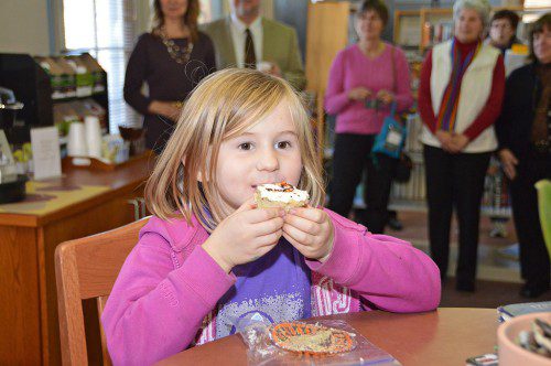 NOT YOUR GRANDFATHER'S LIBRARY. Abby Meier enjoys a cupcake at the reception and open house for the dedication of the Flint Memorial Library's new Browsing Cafe. (Bob Turosz Photo)
