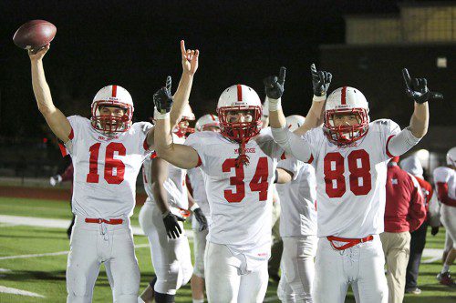 MELROSE FOOTBALL has plenty of reason to celebrate. On Friday they knocked out top ranked, undefeated Woburn 20-19 in the D3 Northwest playoffs. Pictured celebrating after the victory are (left) quarterback Jake Karelas, Jack Hickey and Cameron Hickey. (Donna Larrson photo) 