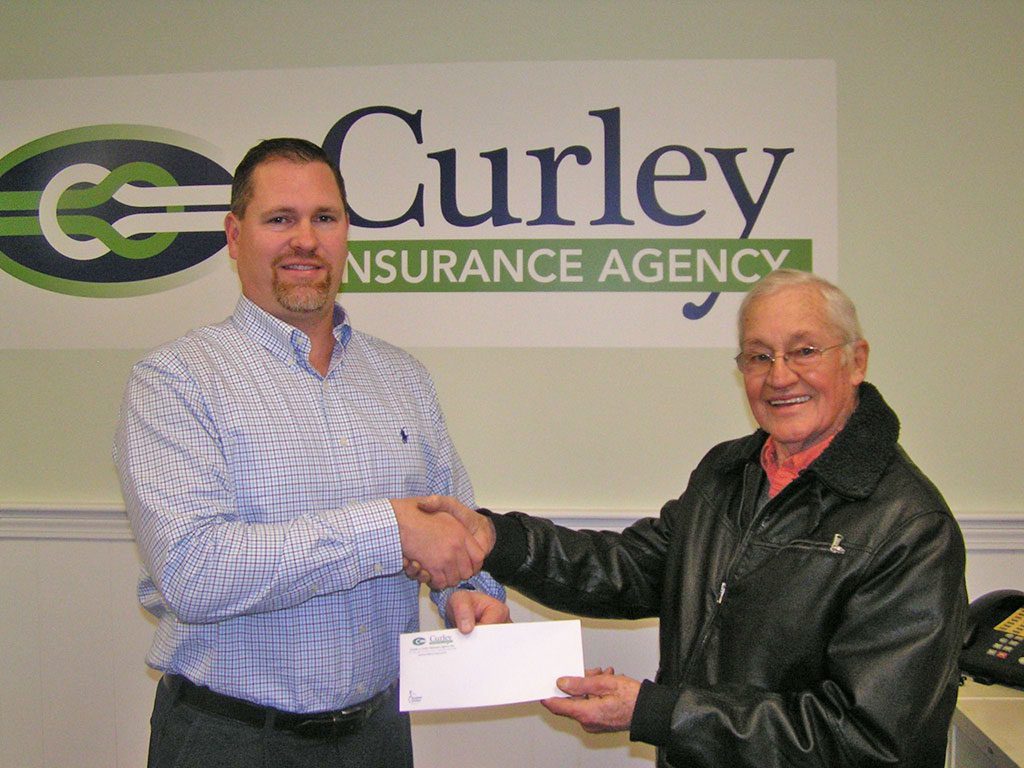 LOUISE AVENUE resident Martin Venus (right) receives his weekly prize from Rob Curley of Curley Insurance. Venus was the Week 6 winner of the 53rd annual Daily Item Football Contest with an 8-3 record and won out in a five-way tiebreaker. Check out the Daily Item Football Contest each week for 11 weeks during the fall season. This week’s picks ran on Pages 6 and 7 in Tuesday’s edition Daily Item. (Jim Southmayd Photo)