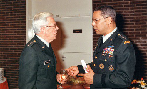 AMONG THE HIGHEST ranking military leaders of the early 1990s, four star U.S. Army Generals John Galvin (left) and Colin Powell discuss world affairs. (Photo courtesy of Mark Curley)