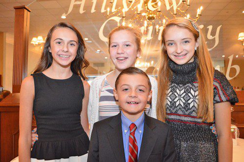 THREE MIDDLE SCHOOL GIRLS volunteered to serve as greeters at the front door of the Hillview Country Club for Sunday's annual Senior Citizen Thanksgiving dinner. Girls, all seventh graders, from left: Alexis Jones, Sophie Hampoian and Elizabeth Barrett, with Nicholas Jones, who said Grace at the dinner. (Bob Turosz Photo)