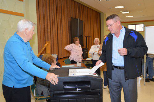 HE'S NOT ON THE BALLOT, but that didn't stop Town Moderator John Murphy from casting his vote in Precinct 4 on Tuesday. At left is election worker Ron Annand. (Bob Turosz Photo)