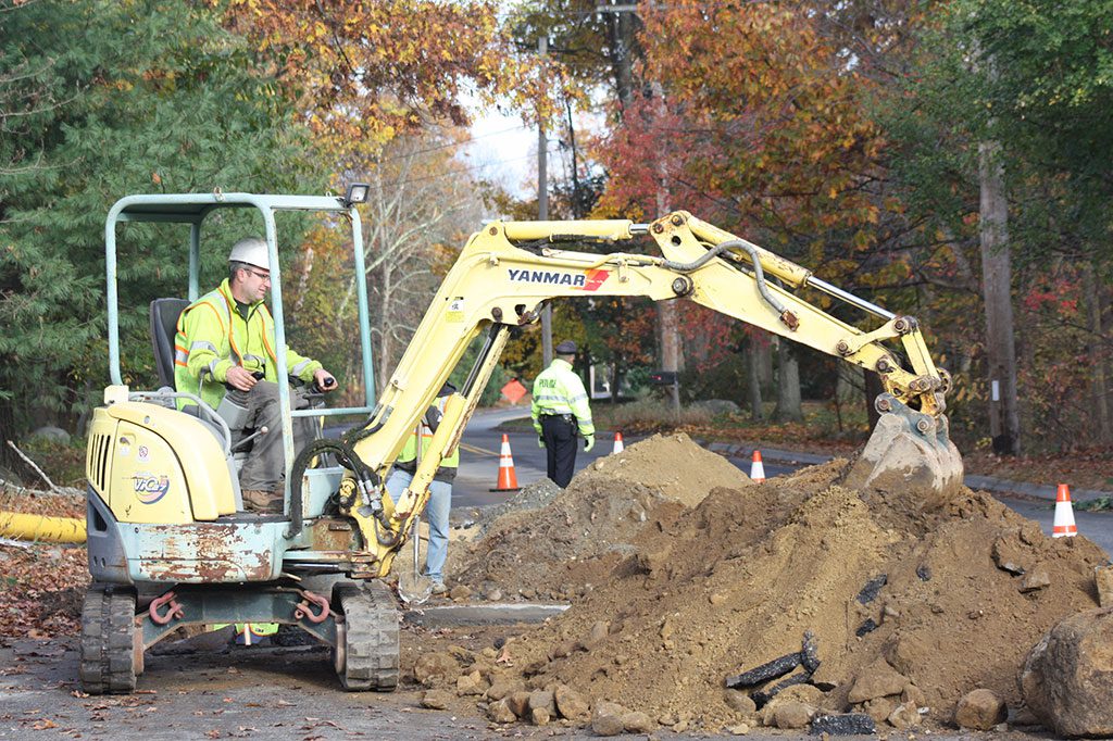 CONSTRUCTION crews working on behalf of National Grid dig a trench for new gas lines being installed on Lowell Street, near Messiah Lutheran Church on Thursday morning.      (Maureen Doherty Photo)