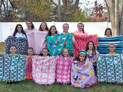 NORTH READING GIRL SCOUT Troops 71880 and 85193 recently worked together during a day off from school to make blankets for Project Linus, a non profit organization which provides homemade blankets to children in need. Pictured are: Back row, Julia Craig, Kaela Aalto, Tori Piscatelli, Makenna Lamont, Emma Lord, Julia DiNapoli, and Izzy Milone. Front row, Jenna DiNapoli, Kylie Gettings, Tiara Lamont, Jayden Craig, Sophia Barker, Riley Garrity and Erica Pepper. (Courtesy Photo)
