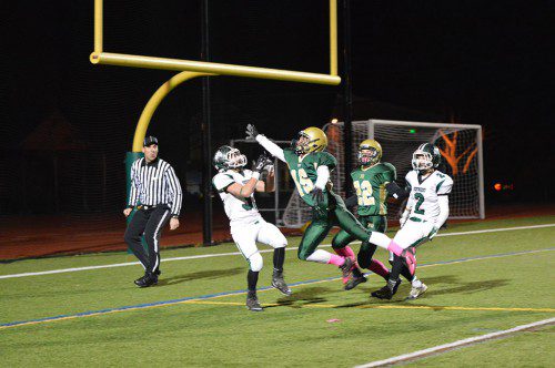 SAVING THE SHUTOUT. Hornet Junior Nick Copelas (16) breaks up Pentucket's attempt at a touchdown pass in the second quarter to preserve the 21–0 shut out for North Reading. Number 22 for the Hornets, David Smith, scored all three North Reading touchdowns. (Bob Turosz Photo)