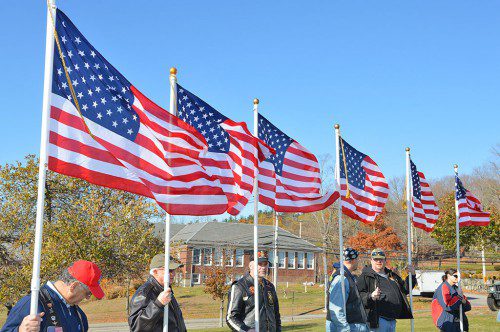 PROUDLY WE HAIL. A ring of American flags on the town common carried by Patriot Guard Riders symbolize the patriotic sentiments of North Reading on Veterans Day. (Bob Turosz Photo)