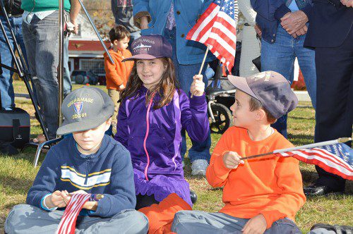 YOUNG PATRIOTS. Jonah, Eva and Elijah Roberts celebrate Veterans Day along with crowd of about 200 during ceremonies on the town common Tuesday morning. (Bob Turosz Photo)