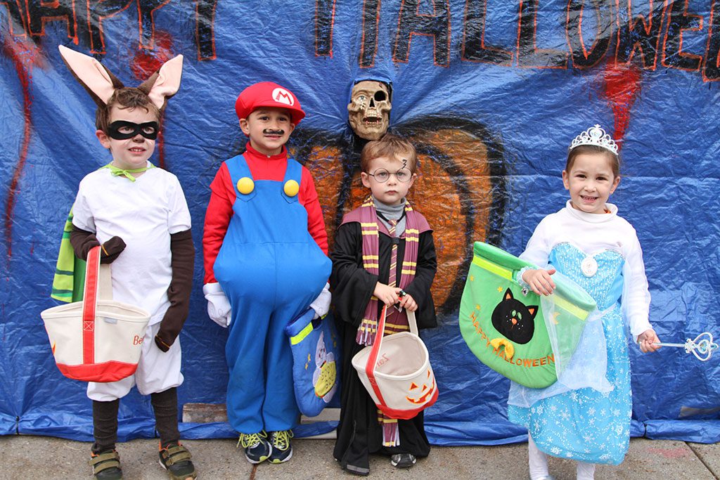 THE FOLKS AT WHITTEMORE HARDWARE always have a great time on Halloween, and this year was no different. Here in front of the Main Street store are five year old Bennet McGravey, five year old Anthony Kiatos, Xander McGravey, 4, and Alexandra Kiatos, also 4, during the Chamber of Commerce-sponsored trick or treating event last Friday. (Donna Larsson Photo) 