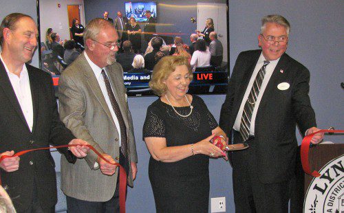 THE VISIONARY leadership provided by the late Al Merritt in the development of MarketStreet was commemorated with the dedication of the Al Merritt Media and Cultural Center Friday night.  Participating in the ribbon cutting were, from left: Ted Tye of National Development, Town Administrator Bill Gustus, Beverly Merritt and Chairman of the Board of Selectmen Dave Nelson.         (Mark Sardella Photo)