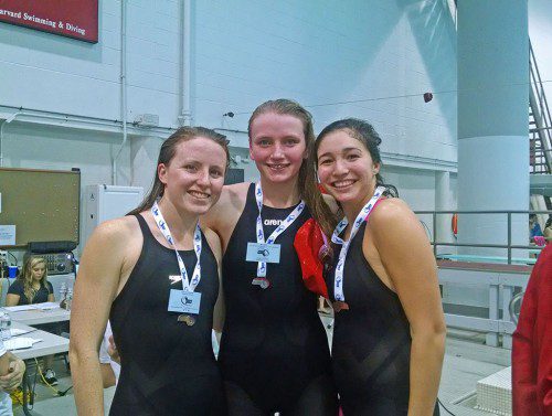 SENIOR SHANNON Quirk (left) is pictured with a pair of Winchester swimmers during the Div. 2 All-State Meet last night at Harvard University. Quirk captured the title in the 500 freestyle and finished third overall in the 200 freestyle.