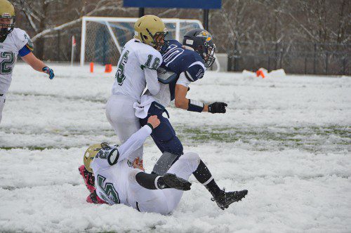 SNOW MEN. Hornet defenders Nick Copelas, (16) and Matt McCarthy, (25), take town their Pioneer opponent on this attempted pass play. (Bob Turosz Photo)