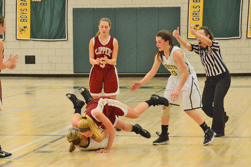 NON CONTACT SPORT? Hornet junior Carli Eldridge shows great hustle by going to the floor with her Newburyport opponent to fight for a loose ball. At right is Hornet captain Adrianna Flanagan. (John Friberg Photo)