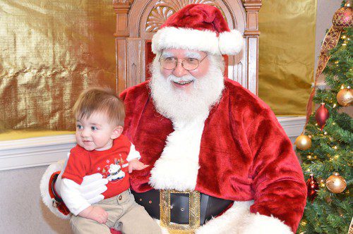 GRANT PLUNKETT, 7 1/2 months, bonded immediately with Santa Claus at the Reading Co–operative Bank during the town's Holiday Lighting Festival sponsored by the Reading–North Reading Chamber Commerce. (Bob Turosz Photo)