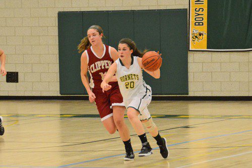 UP COURT. Senior Captain Adrianna Flanagan pushes the ball up court for the Hornets. Flanagan finished with 15 points and 9 rebounds in the season opener against Newburyport. (John Friberg Photo)