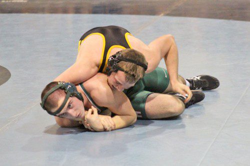 SENIOR CAPTAIN Austin Bradley (on top) defeated his Hopkinton opponent by a 7-0 decision in the 182 lbs. on Saturday, Dec. 13. The Black and Gold have opened the 2014-2015 season with a 2-1 record.                (Courtesy Photo)