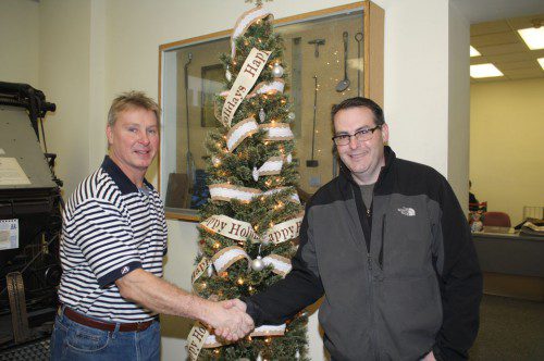 A BEAUTIFULLY decorated Christmas tree, donated by the Wakefield Daily Item, was won in a raffle by Josh Wallace of Wakefield (right) during the town’s annual Holiday Stroll festivities on Dec. 6. Congratulating Wallace is Jim Dolbeare of the Wakefield Daily Item. (Maureen Doherty Photo)