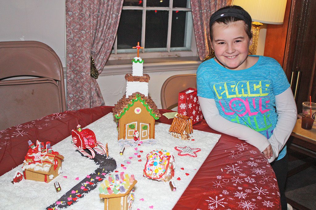FOURTH GRADER Kiera Mallett and the rest of Mrs. Tavaro’s fourth grade CCD class were co-winners of the Best Holiday Spirit category in this year’s Gingerbread House Contest. (Dan Tomasello Photo)