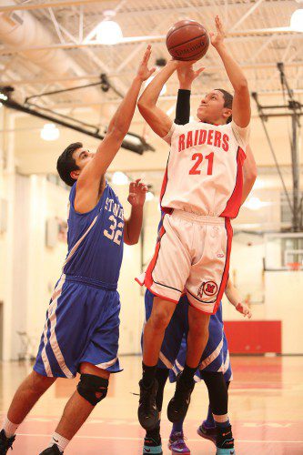 THE MELROSE Red Raider basketball picked up two straight wins last week over Reading and Lexington to remain in second place in the Middlesex Freedom League. Pictured is senior captain Will Caffey. (Donna Larsson photo)