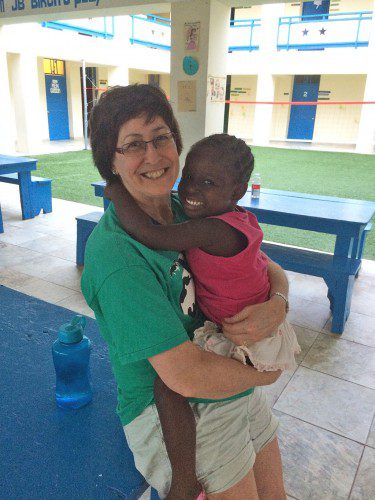 LOCAL OPHTHALMOLOGIST Dr. Vicki Kvedar hangs out with an orphan at the Be Like Brit orphanage in Haiti. Dr. Kvedar visited the orphanage with her daughter, Julie, on a medical mission Jan. 11-18. The Kvedars treated the orphanage's 66 children and 78 staff members during the medical mission. (Courtesy Photo)