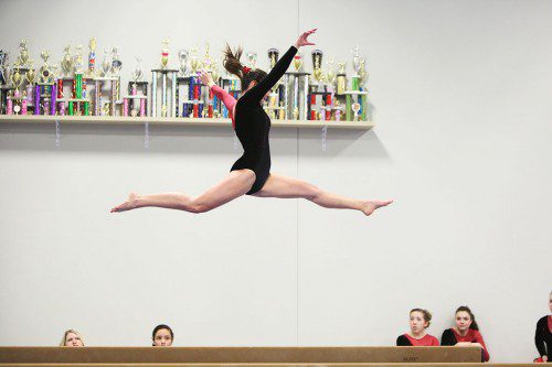 SPRINGING TO success. The Melrose High School girls gymnastics team improved to 3-0 with wins over Wakefield and Burlington last week. Pictured is senior captain Audrey McFarland on the beam. (Donna Larsson photo)