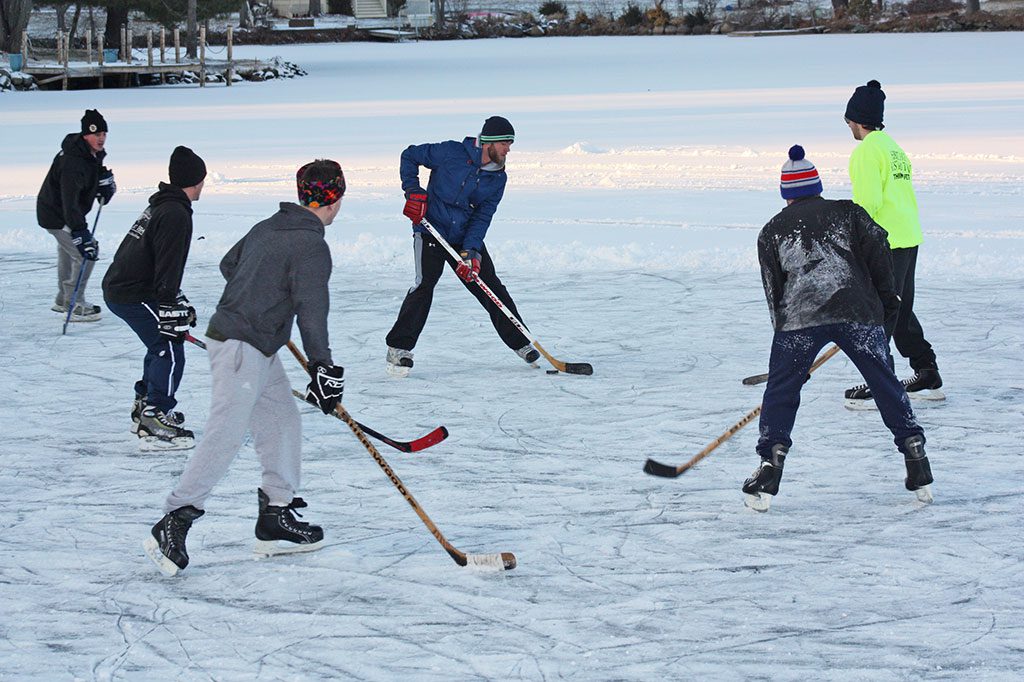 A GROUP OF YOUTHS took advantage of a temporary break from last week’s arctic blast to play a pick-up hockey game on Pillings Pond Jan. 9.      (Dan Tomasello Photo)