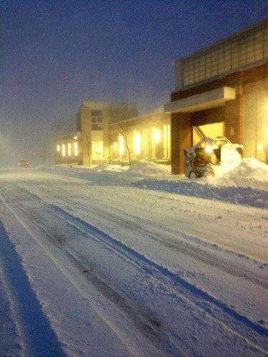 LIKE JUST ABOUT every main road in eastern Massachusetts, North Avenue had barely any traffic this morning before dawn. In this photo, the front of the Municipal Gas and Light Department is cleared of snow. (Colleen Riley Photo)