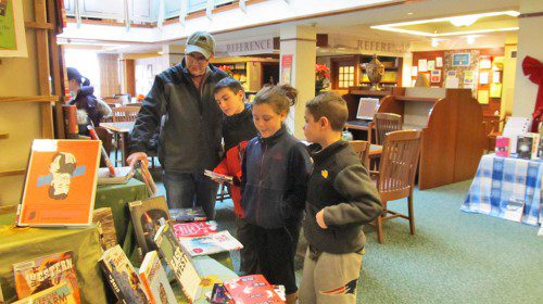 THE Wallace family, residents of the West Side of town, went to the Beebe Library over school vacation to check out some books. (Gail Lowe Photo)