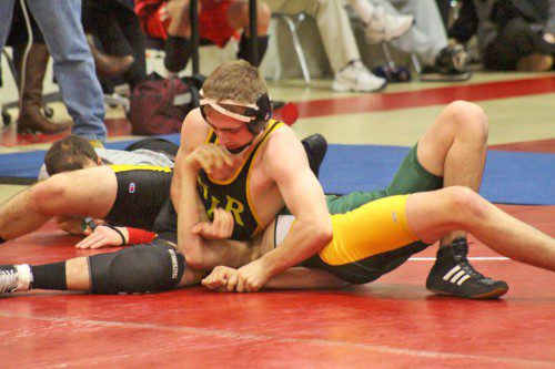 SENIOR CAPTAIN Lucas Pascucci (on top) defeated his Southwick-Toland counterpart by fall in 1:53 on Jan. 17. The Black and Gold defeated Southwick-Toland 66-9. (Courtesy Photo)