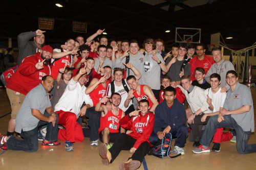 THE MEMBERS of the WMHS boys’ indoor track team celebrated after learning it had captured the Middlesex League Freedom division championship outright. The final result was in question, however, after Burlington lodged a protest of the results of the 45 yard dash this morning. The matter was still being reviewed at press time.  (Donna Larsson Photo)