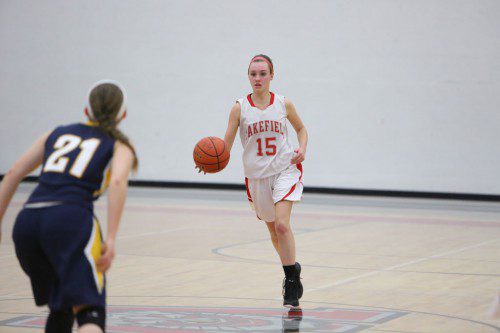 GRACE HURLEY, a junior guard (#15), dribbles the ball up the court during a recent game. Hurley scored four points for the Warriors in their 51-43 road loss against Arlington yesterday afternoon. (Donna Larsson File Photo)