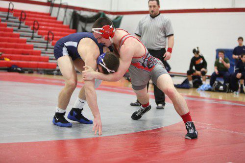 EVAN GOURVILLE, a junior (right), posted a victory by pin at the 160 weight class in Wakefield's meet against Wilmington. The Warriors tamed the Wildcats, 54-27, to pull to within one win of a Middlesex League Freedom division championship. (Donna Larsson File Photo)