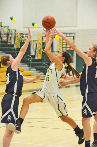 SOPHOMORE GUARD Kat Hassapis drives the lane for two points in the Hornets' final game against Medway. (John Friberg Photo)