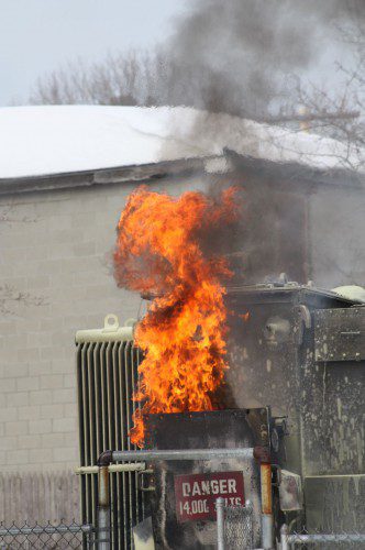 A BALL of orange flames and black smoke rises above the transformer at the WMGLD substation on Wakefield Avenue Wednesday afternoon as its fuel source burned off. (Maureen Doherty Photo)