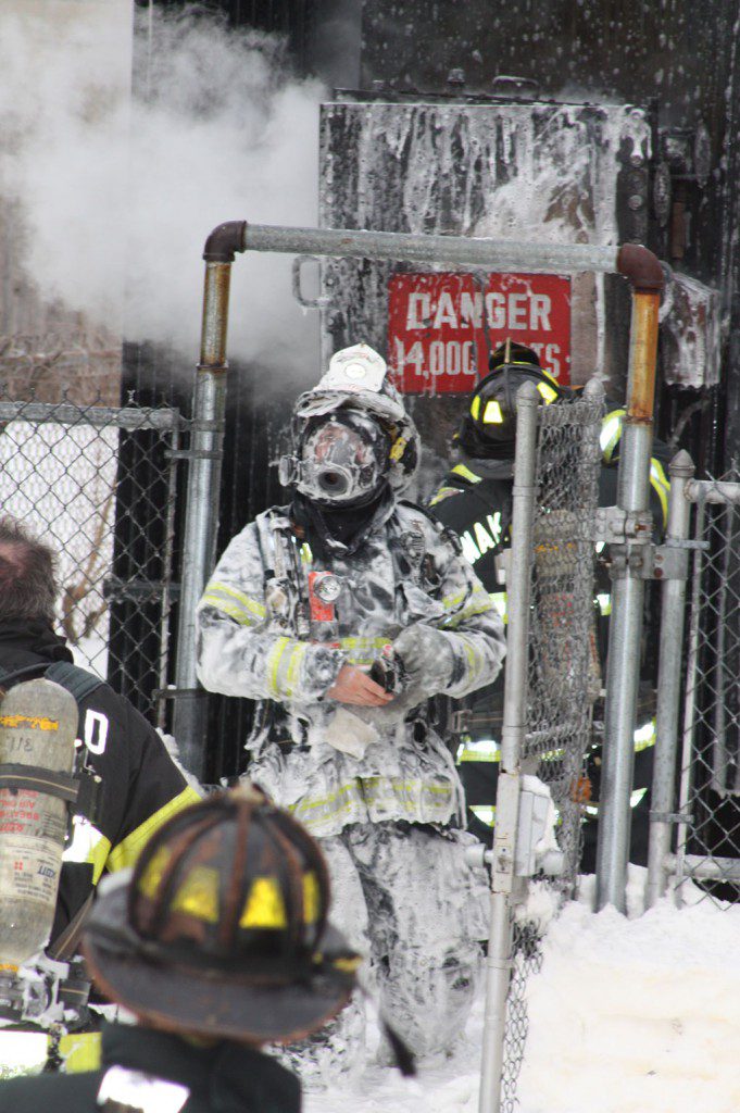 A FOAM-COVERED firefighter emerges from the WMGLD substation yard after helping to suppress a transformer fire last Wednesday afternoon. Firefighters from Engine 3 at the South Lynnfield Fire Station brought their foam tank and trailer with extra foam to assist in knocking it down. (Maureen Doherty Photo)