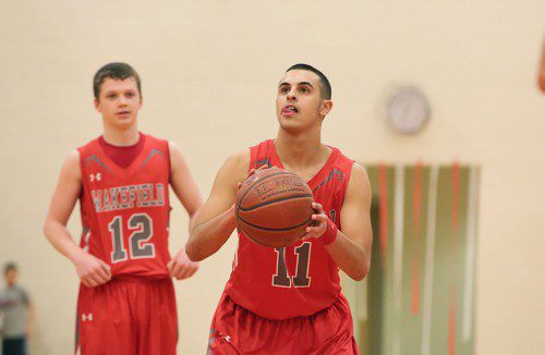 CHRIS CALNAN, a senior guard (#11), prepares to take a shot as teammate Jon Miller (#12) looks on. Calnan was the team high scorer with 18 points as Wakefield dropped 52-47 contest against Melrose last night at the Melrose Veterans Memorial Middle School Gym. (Donna Larsson Photo)
