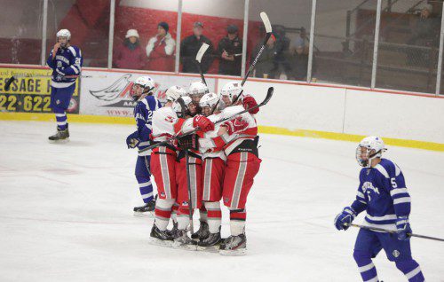 SEVERAL MEMBERS of the Warrior boys’ hockey team celebrated after scoring a goal. Wakefield had more reason to celebrate at the end of the game as it earned its first victory of the season with a 4-3 triumph over Stoneham last night at the Kasabuski Arena. (Donna Larsson Photo)