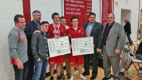 THE WMHS wrestling coaches are pictured with Wakefield’s two Div. 3 state champions. From left to right are Assistant Coach Joe Lauria, Head Coach Ross Ickes, Assistant Coach Mike Petralia, 195 lb. state champion Dan Wensley, Assistant Coach Matt Manfredi, 220 lb. two-time state champion Alex Kane, Assistant Coach Jerry DoVale and Assistant Coach Anthony Lauria. Missing is Assistant Coach John Bosco. Wensley and Kane, along with sophomore Jack Spicer, will be competing in the All-State meet this weekend.