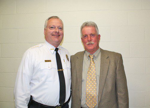 COMMUNITY policing defined the 40-year tenure of recently retired police officer Charlie Peabody (right) who was praised by Police Chief Dave Breen at a special presentation by the Board of Selectmen March 9. (Maureen Doherty Photo)