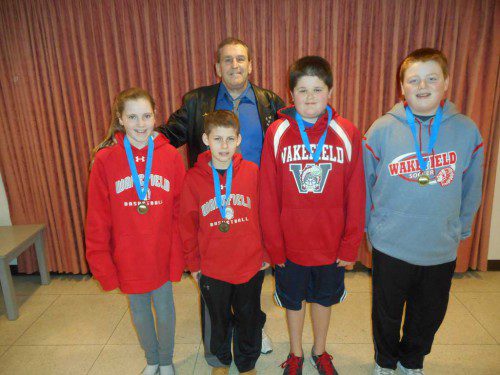 WINNERS IN the Knights of Columbus District Free Throw Championship showing their winning medallions included (front row, left to right) Maeve Gaffney, Max Dimella, Paul Holman and Liam Cosgrove. Standing in back is Grand Knight Jack Roche. (Bob Curran Photo)