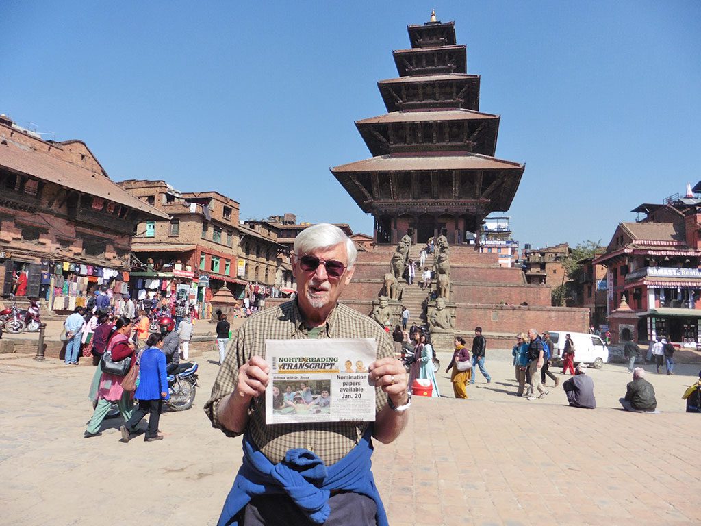 DON'T LEAVE HOME WITHOUT IT. Barbra and Gary Priest recently spent a month traveling through Bhutan, India and Nepal. Here, Gary is shown holding the Transcript in Durbar Square in Bhaktapur "City of Devotees" Nepal. (Courtesy Photo)