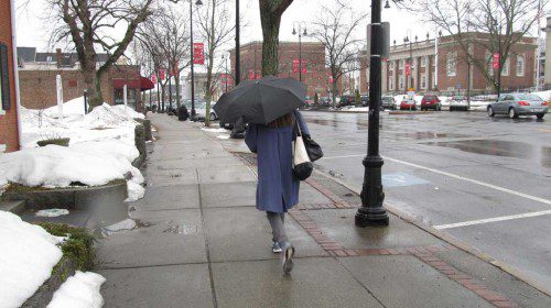 ST. PATRICK’S DAY was a gloomy, rainy day, as a woman walking along Main Street toting an umbrella suggested. (Gail Lowe Photo)